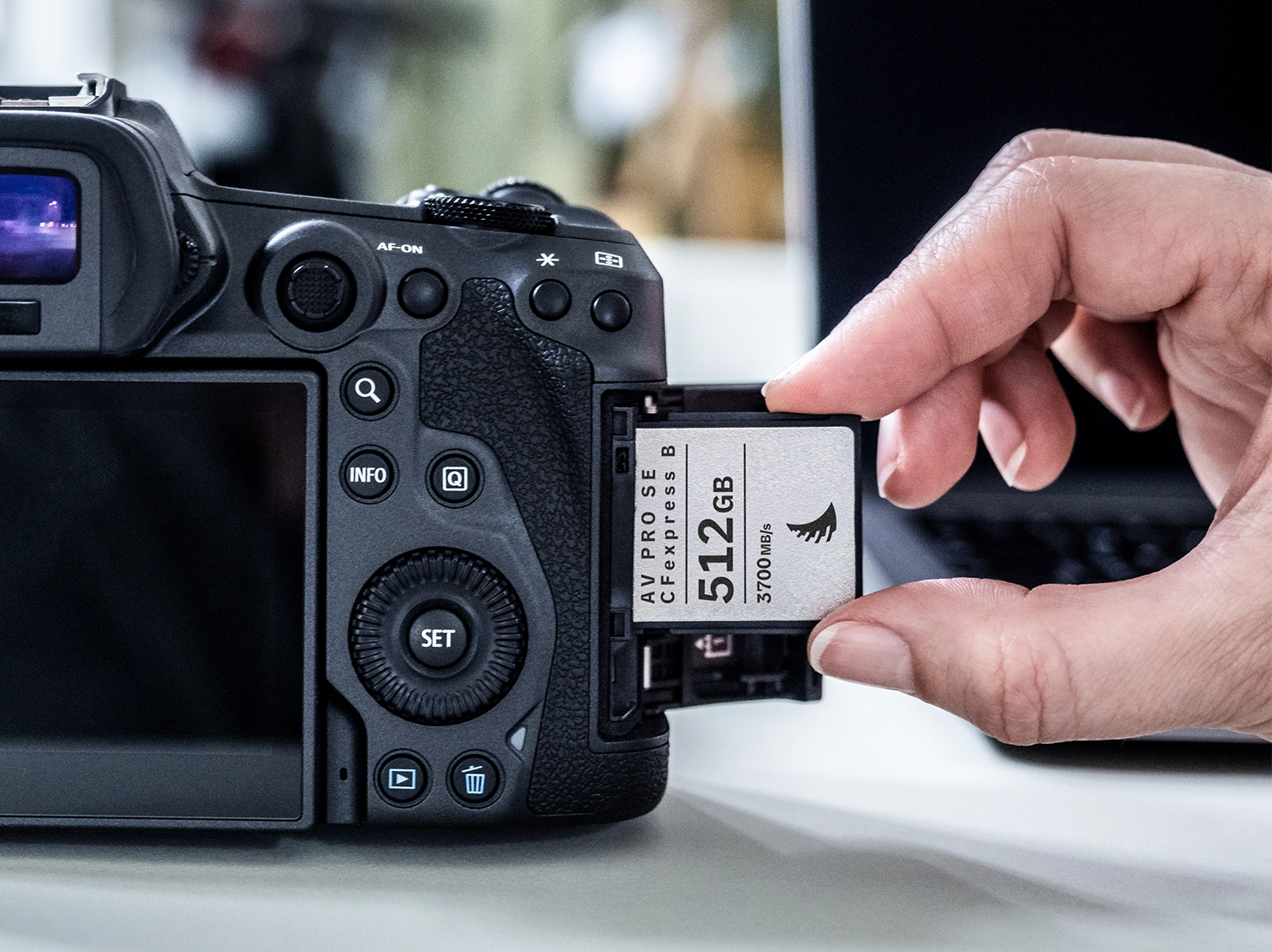 AV PRO SE CFexpress B v4 memory card being inserted sideways in a camera