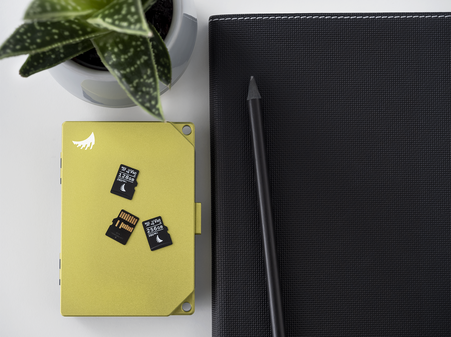 3 microSD V30 memory cards on top of a Media Tank SD next to a notebook