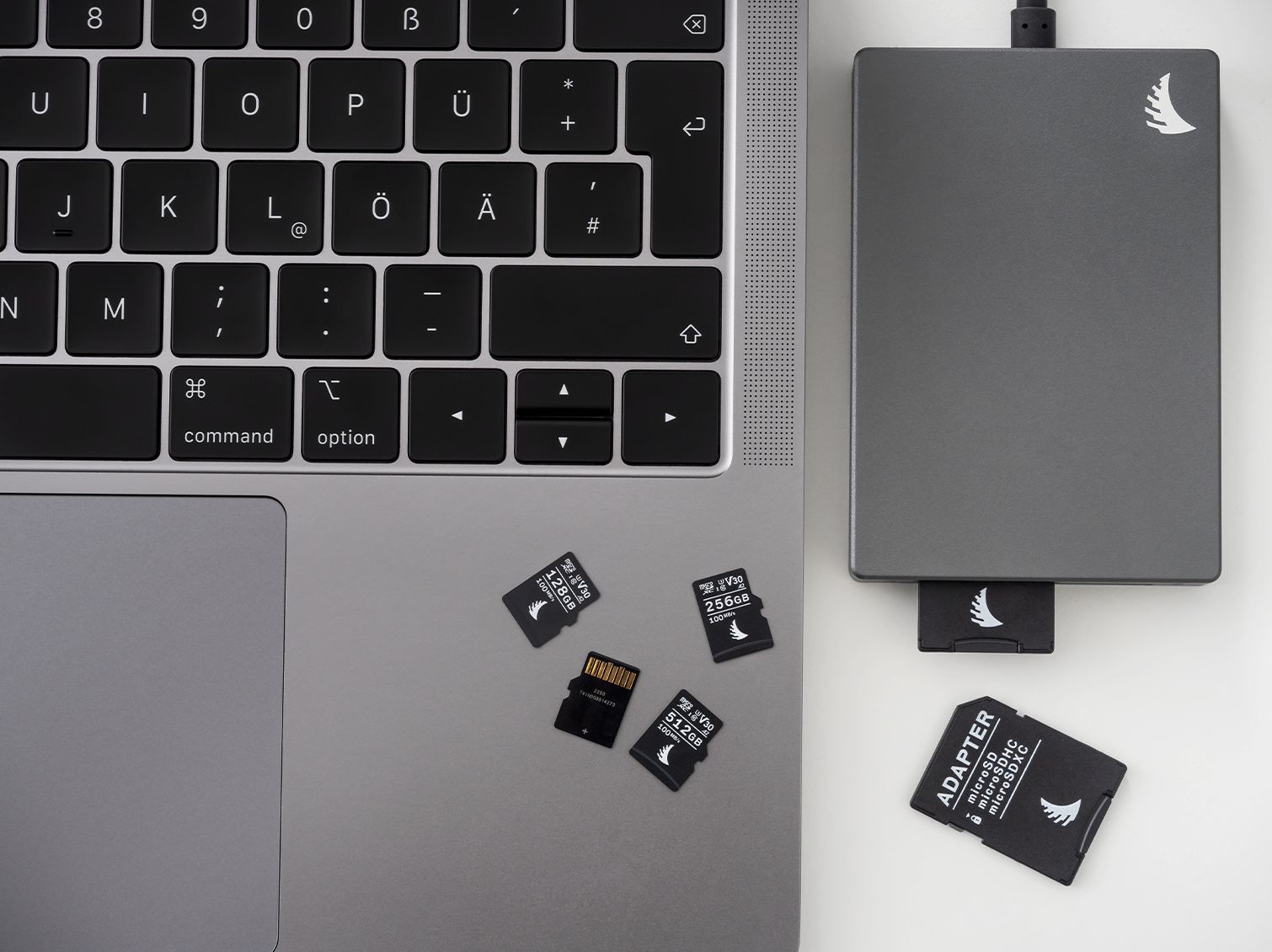4 AV PRO microSD V30 memory cards on top of a computer next to a SD dual card reader