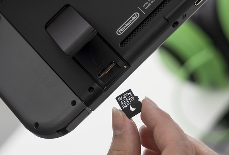 AV PRO microSD V30 memory card being inserted in a gaming console